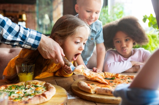 close-up-kids-with-delicious-pizza_23-2148910367
